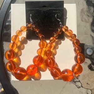 Beautiful orange beaded hoop earrings.